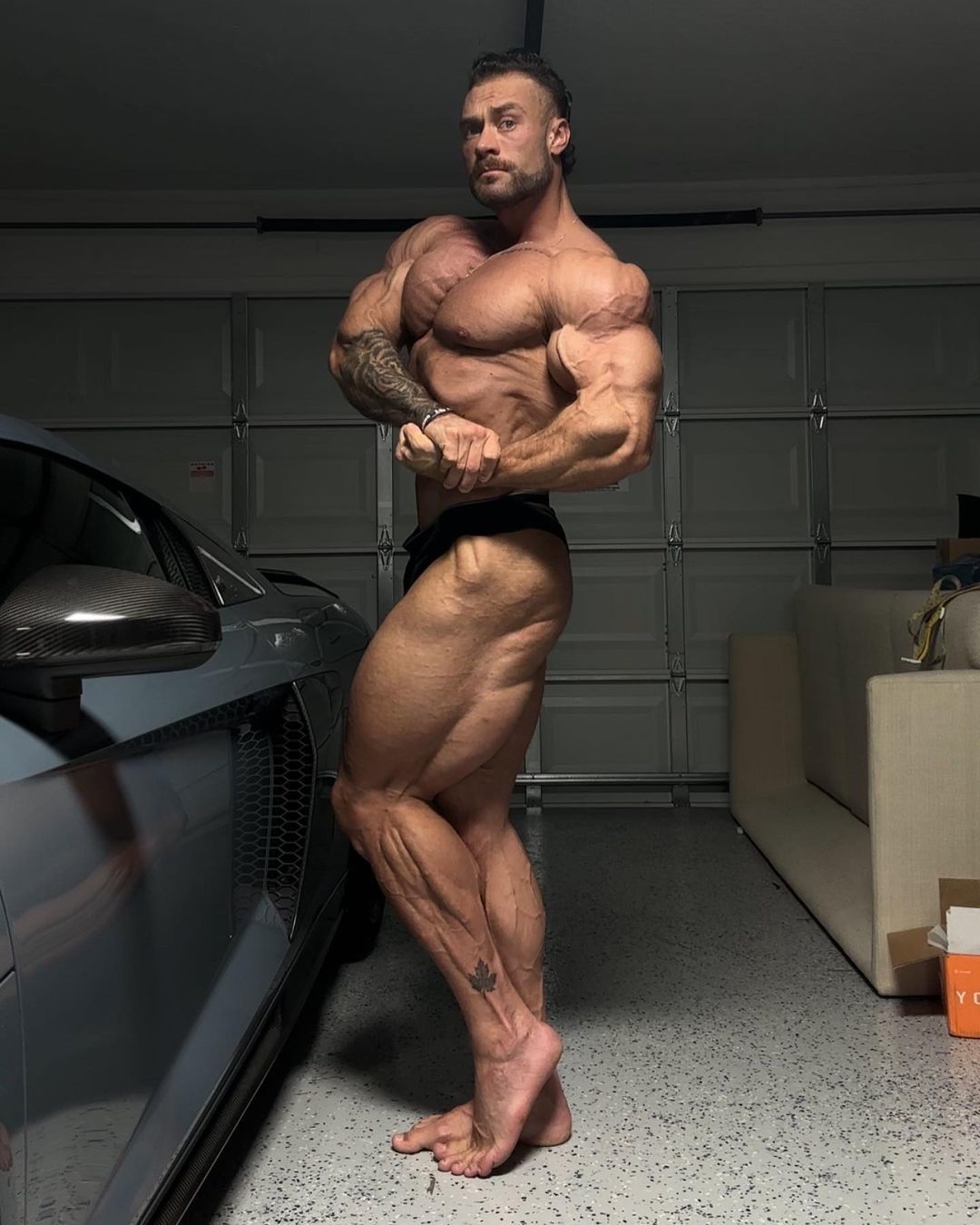 heavy tattooed arms 1:9 handsome chil face Chris Bumstead